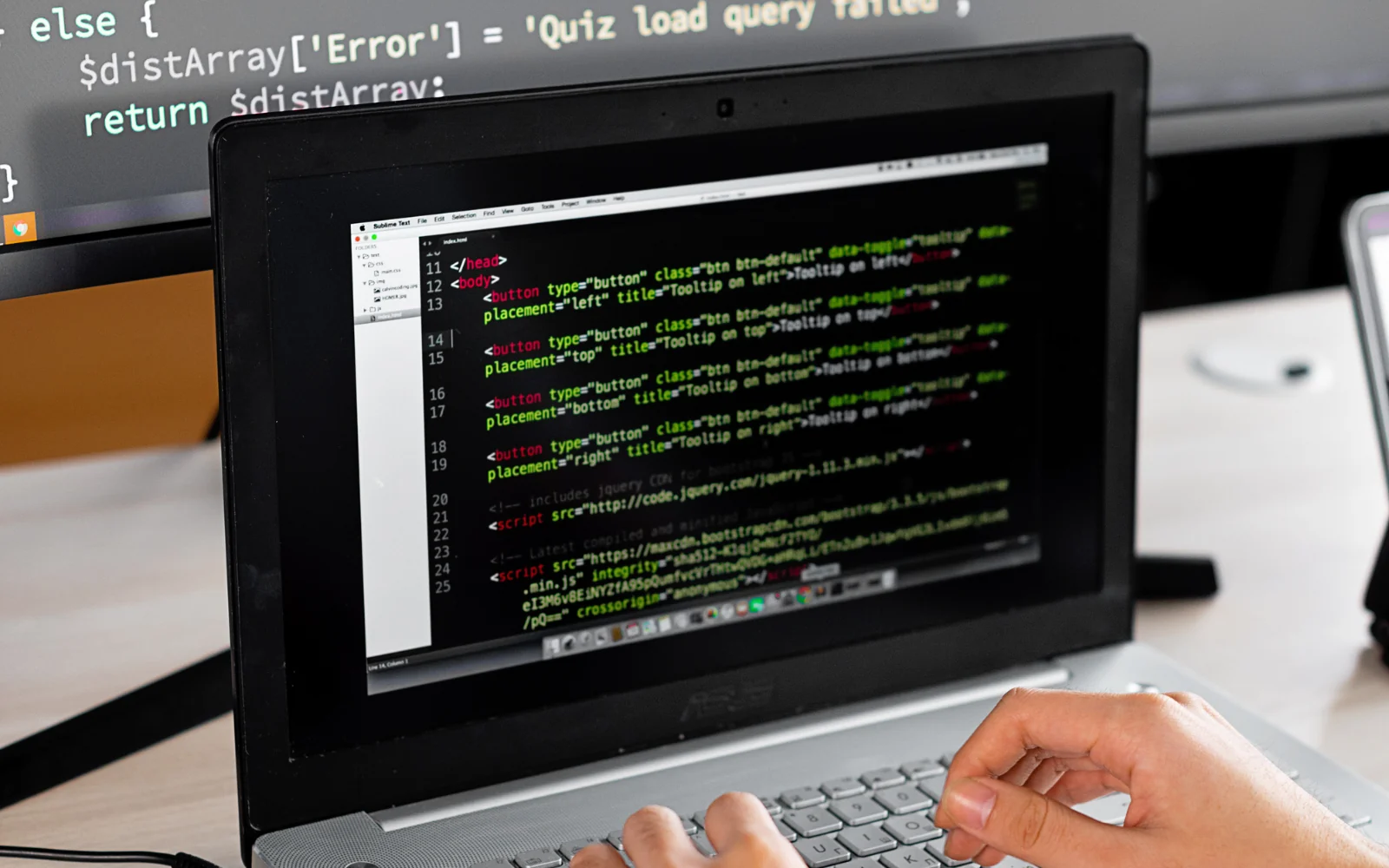 Developer reviewing software source code on a monitor