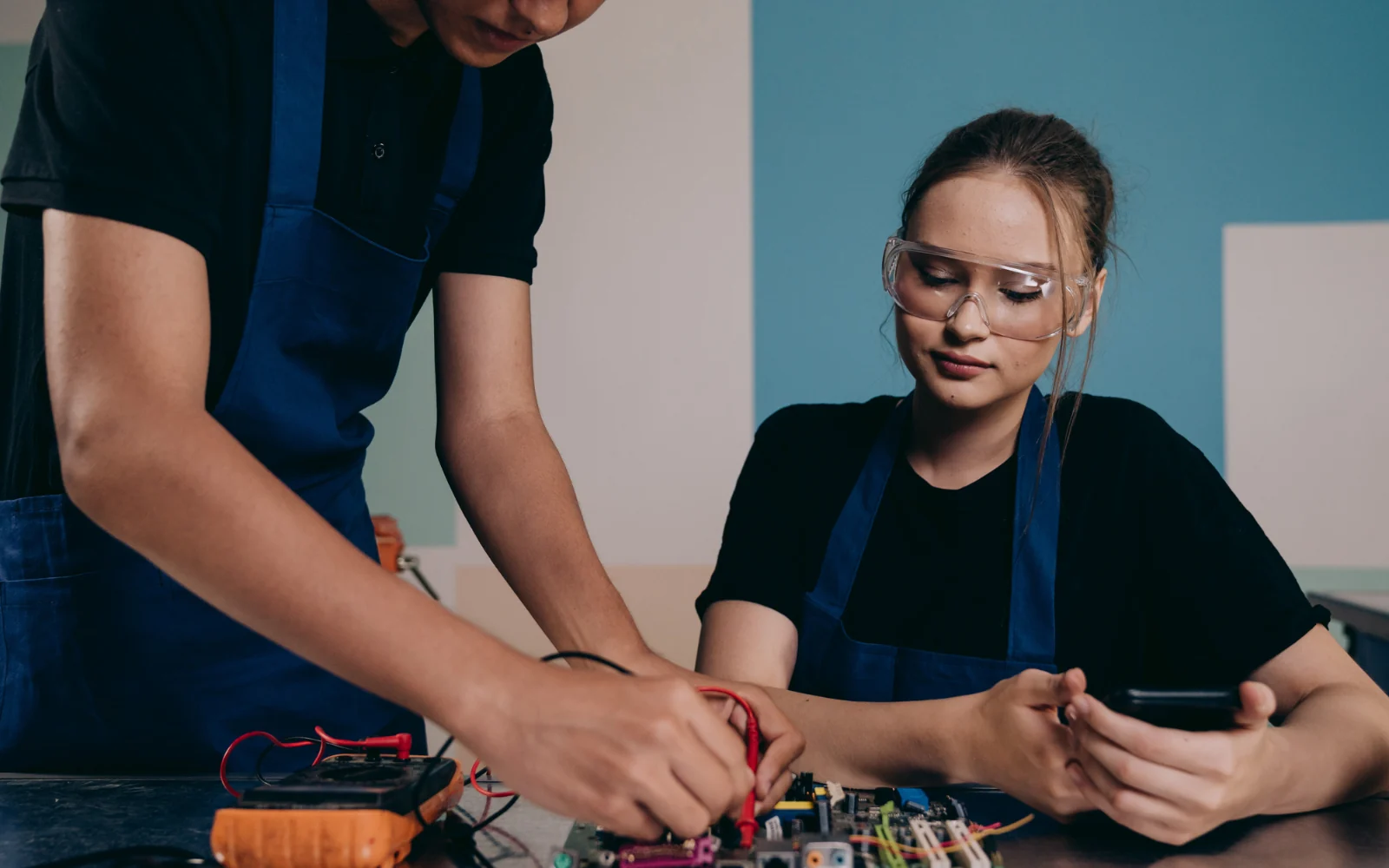 Two engineers examining electronic hardware together
