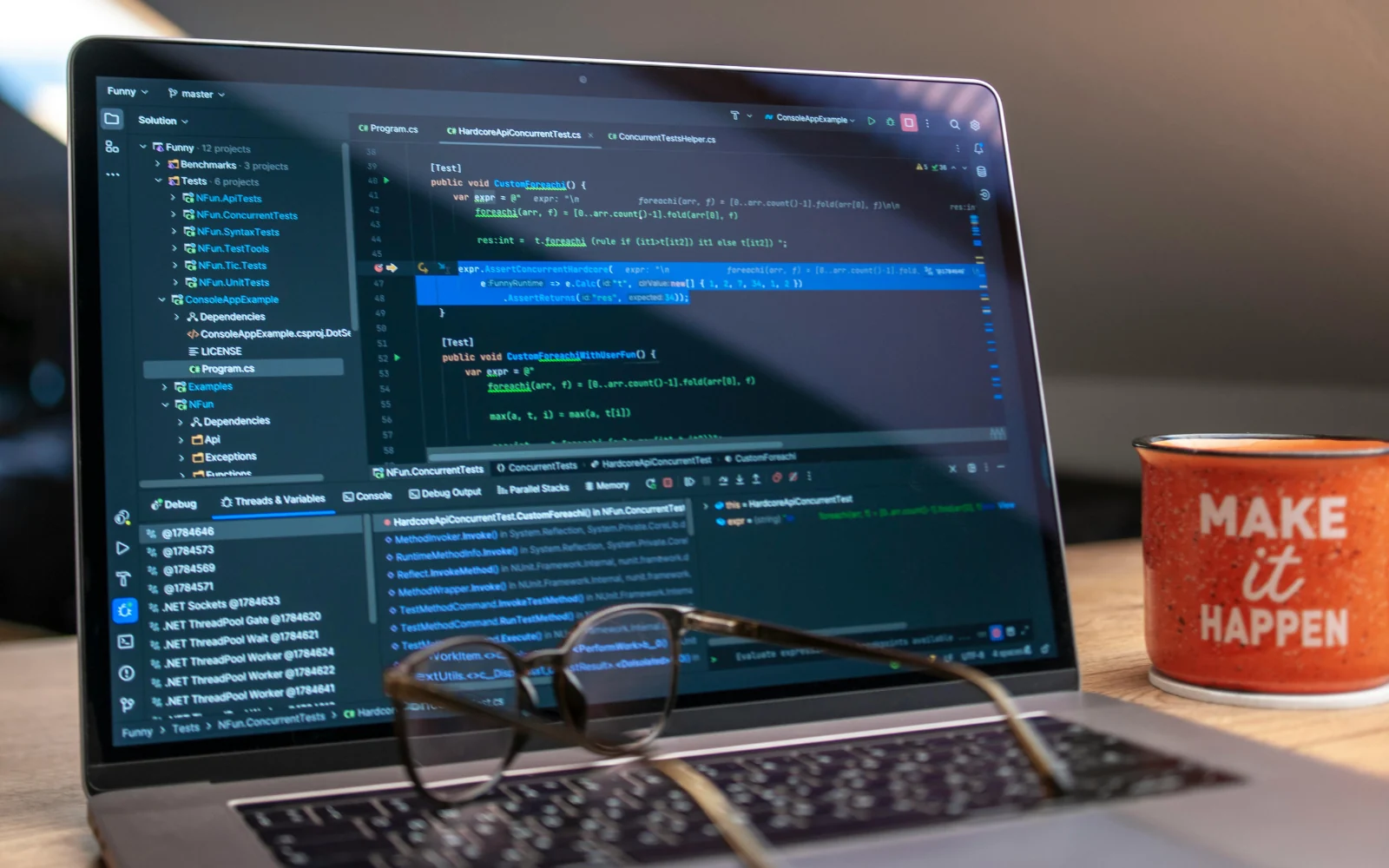 Laptop displaying source code in a software development workspace