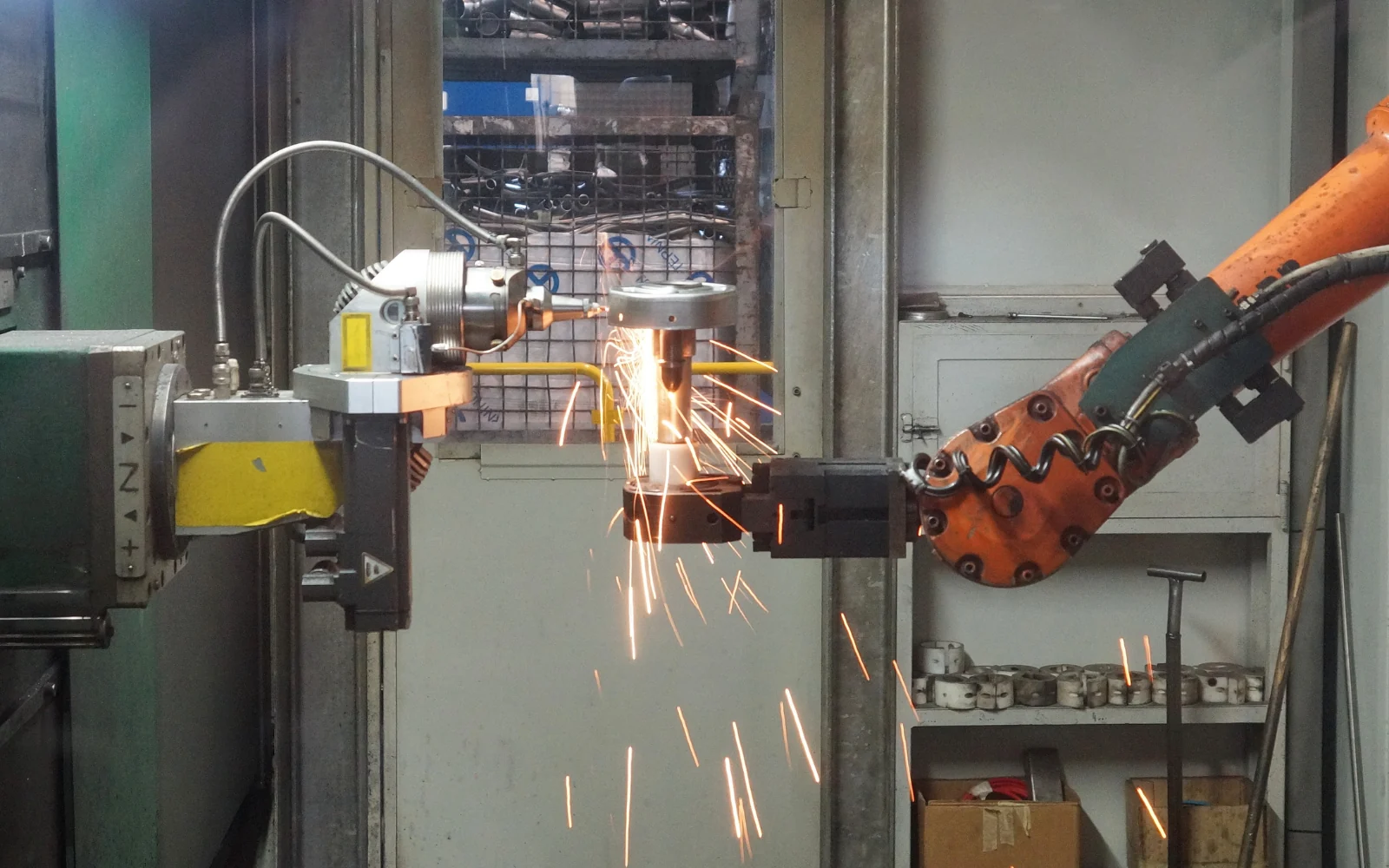 Industrial robotic arm working on a metal component