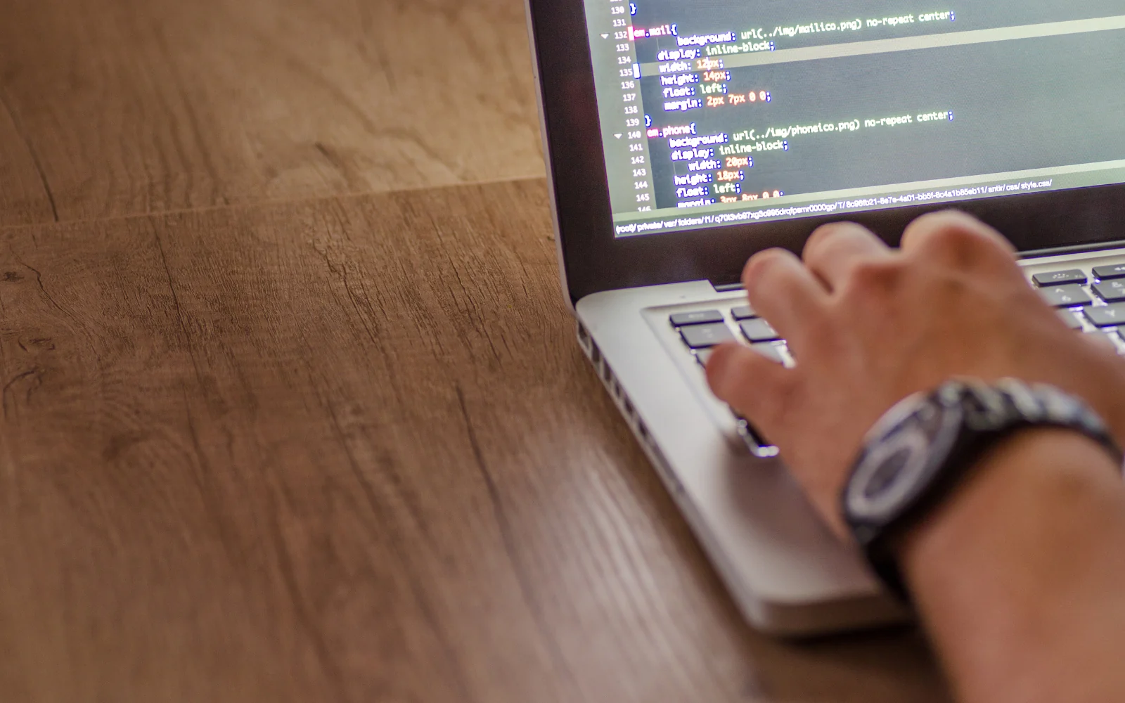 Developer working on source code on a laptop