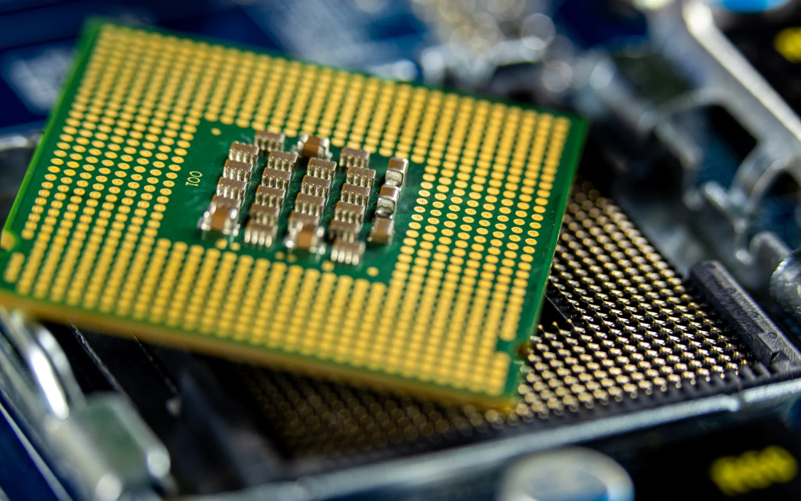 Underside of a processor package above its motherboard socket