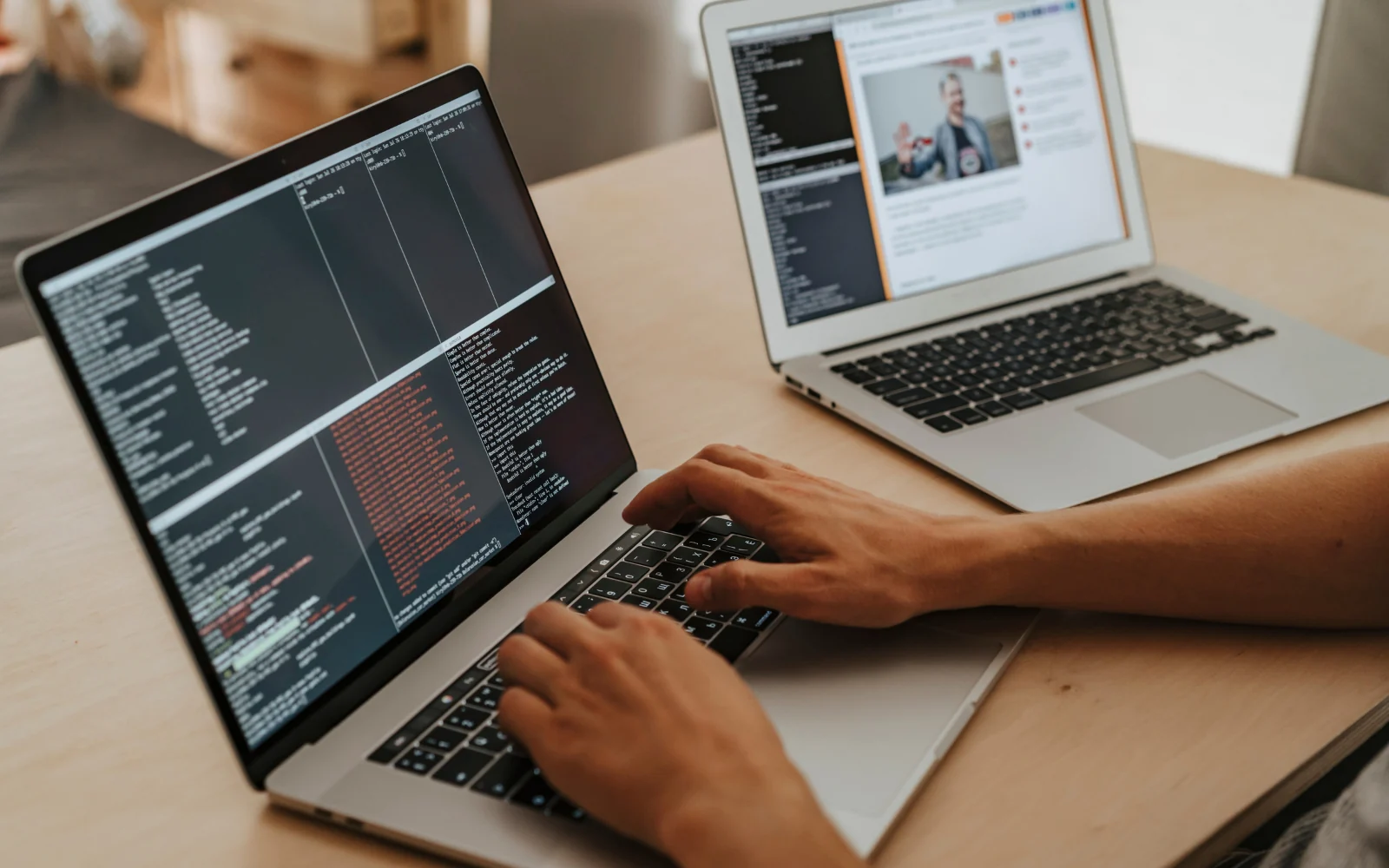 Developer using a laptop alongside a remote collaboration screen