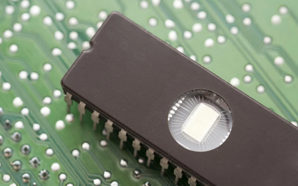 Close-up of a windowed EPROM integrated circuit on a printed circuit board