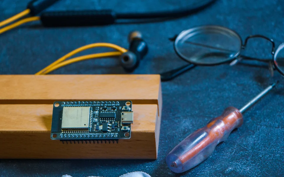 Microcontroller development board and electronics tools on a workbench