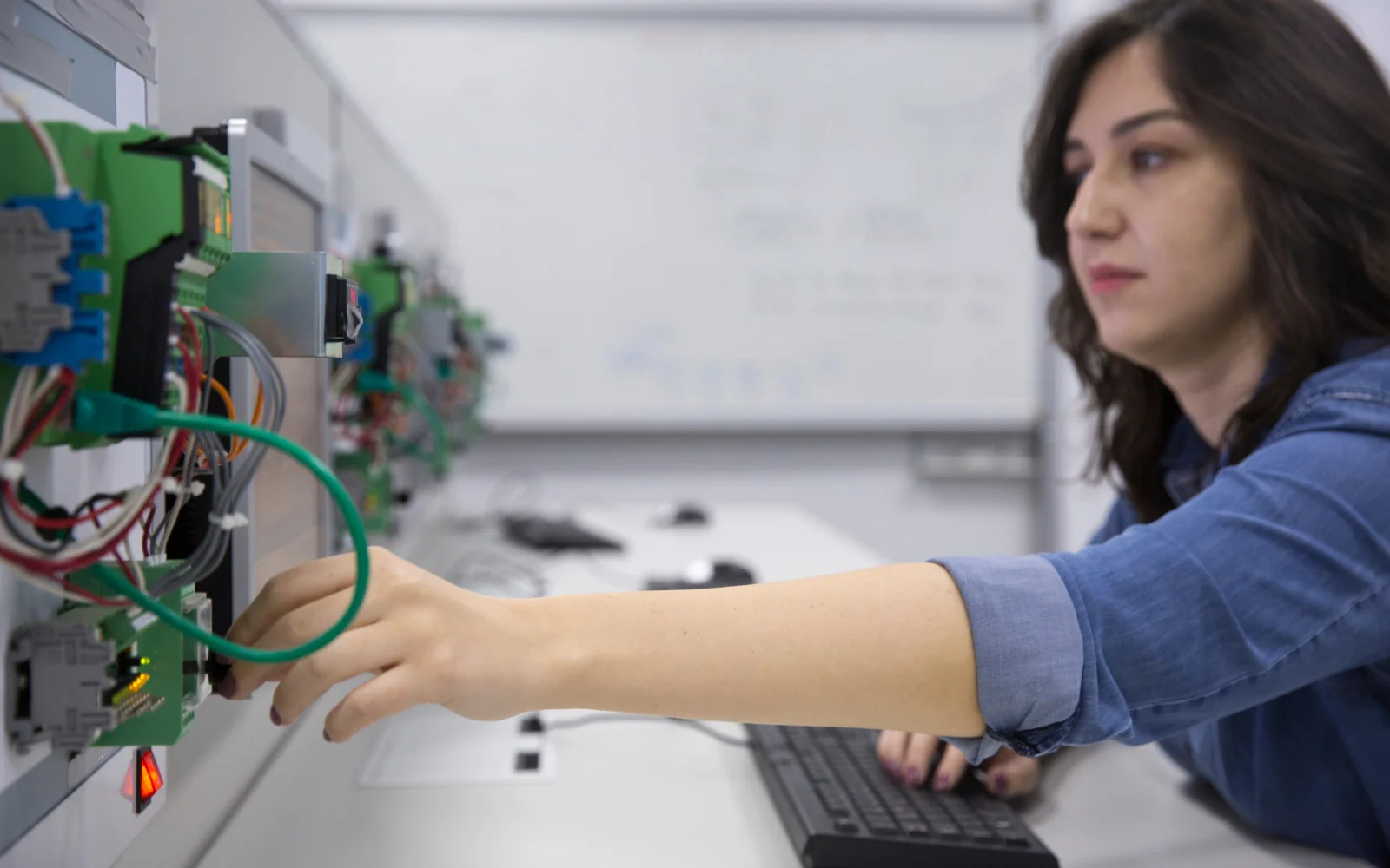 Engineer connecting and checking laboratory electronics