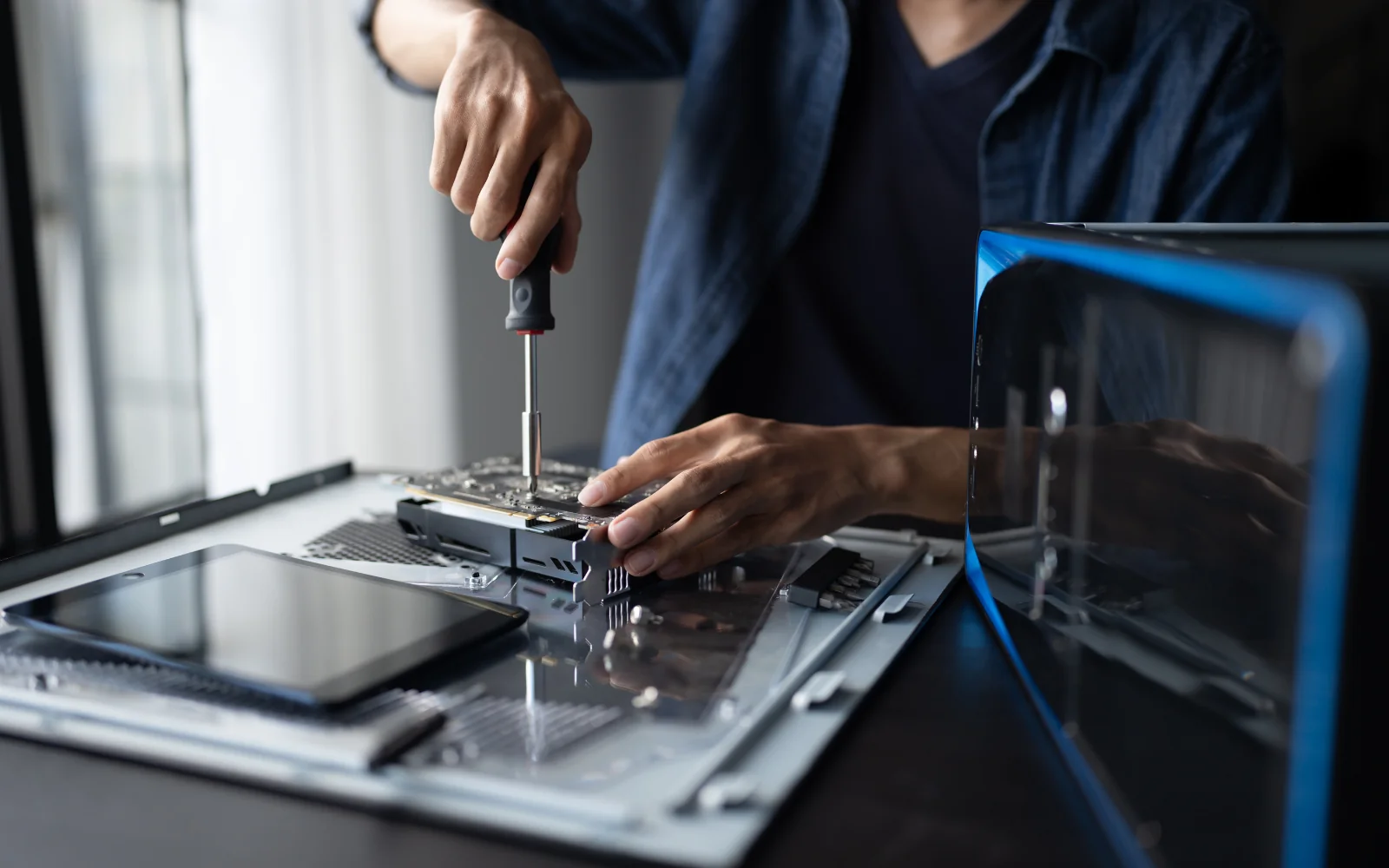 Technician installing hardware in a computer enclosure
