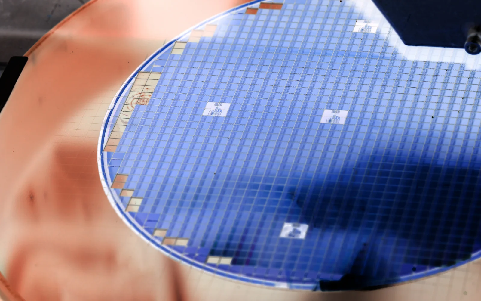 A patterned silicon wafer showing repeated device regions